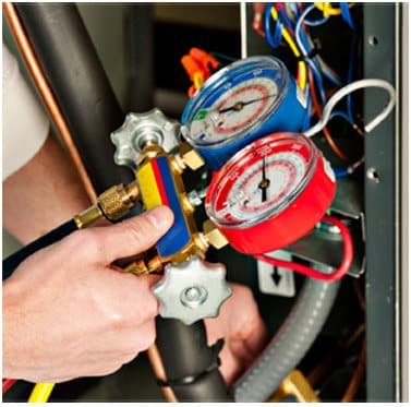 Man checking pressure gauges | LCM Air Conditioning