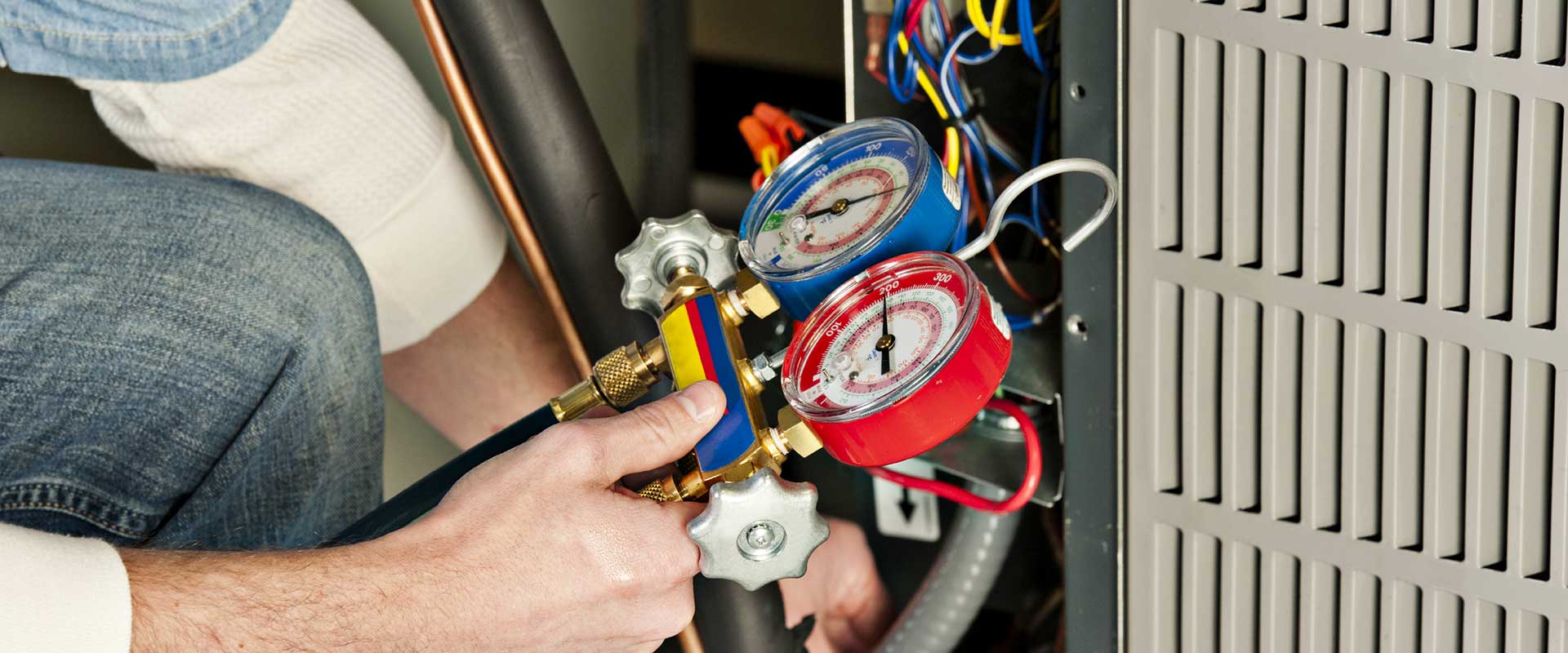 Man checking pressure gauge | LCM Air Conditioning