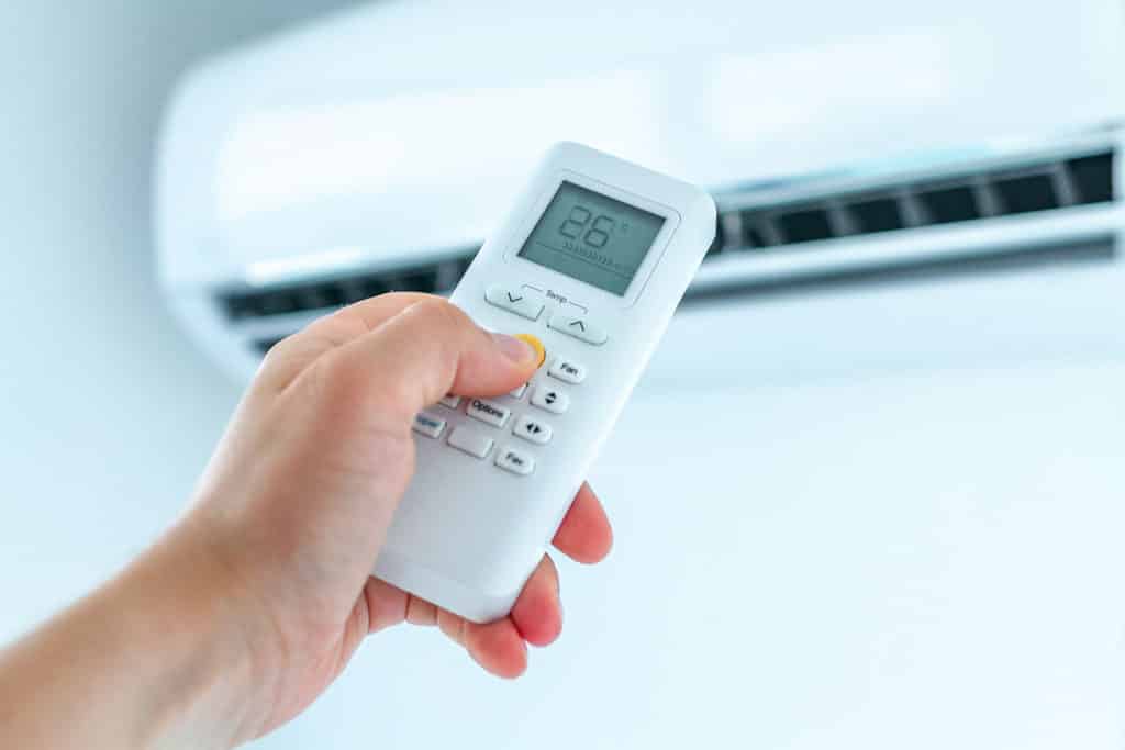 Man using an air con remote | LCM Air Conditioning